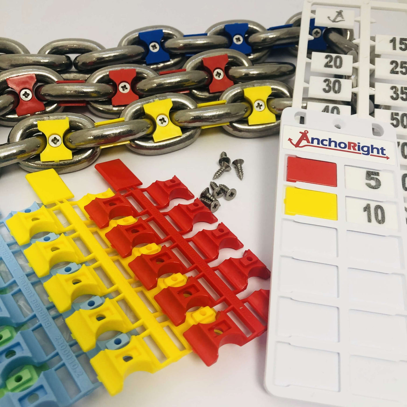An Anchoright chain marking kit: red, yellow and light blue markers fitted to galvanised chain, stainless screws, and the customisable guide plate
